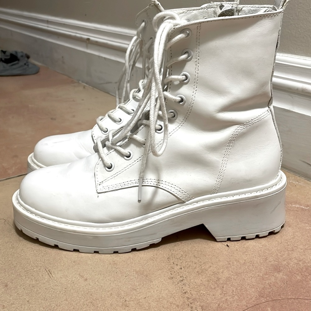 White lace up boots with zip on side.